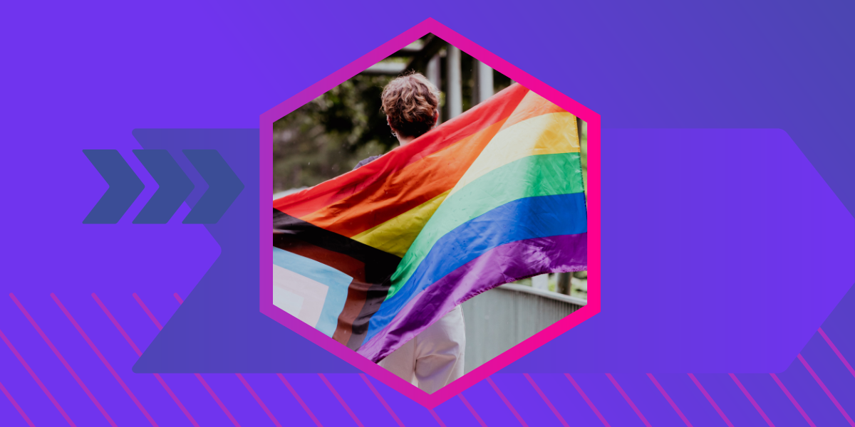 Image of a progressive pride flag being held on the back of a person, depicted in a hexagon shape with a purple background 