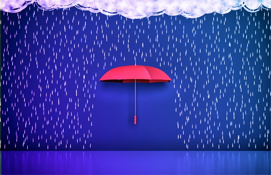 Image of a red umbrella blocking part of the ground from rain all around it